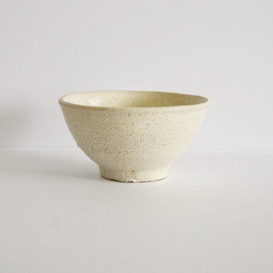 Small deep cream rice bowl with a smooth white slip surface, seen from the side.