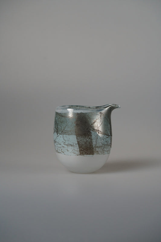 Small white glass pourer banded with a broad silver-grey stripe and a drawn lip.