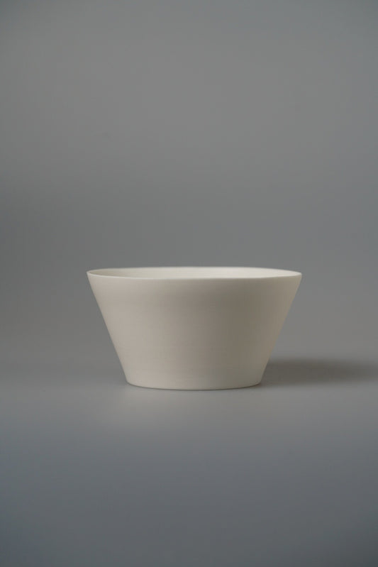Small conical white porcelain bowl with straight flaring sides and a fine rim.