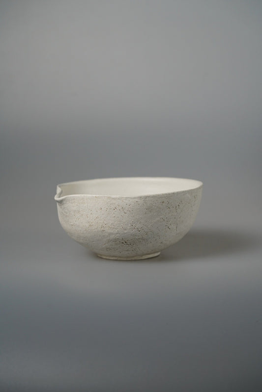 Large cream bowl with a small drawn lip and a lightly speckled matte surface.