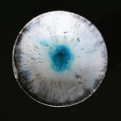 Shallow wood-fired bowl in mottled white and grey with a vivid turquoise pool at its centre.