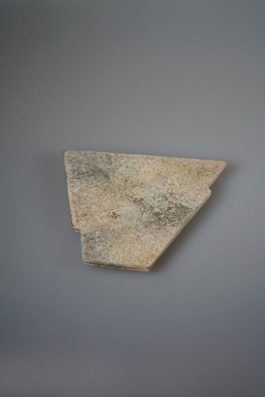 Angular wedge-shaped tray in mottled grey and cream with a rough stone-like face.