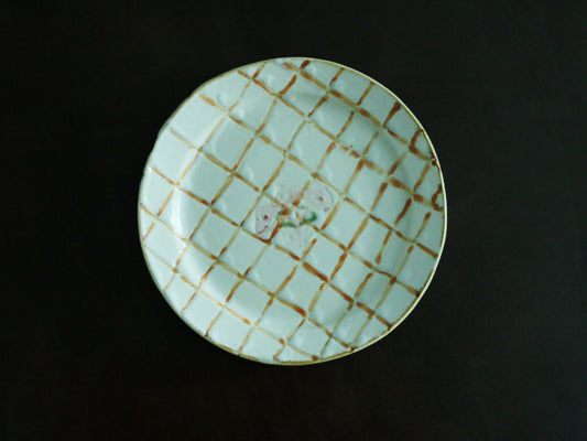Pale green plate hand-painted with a fine gold check grid across its whole face.