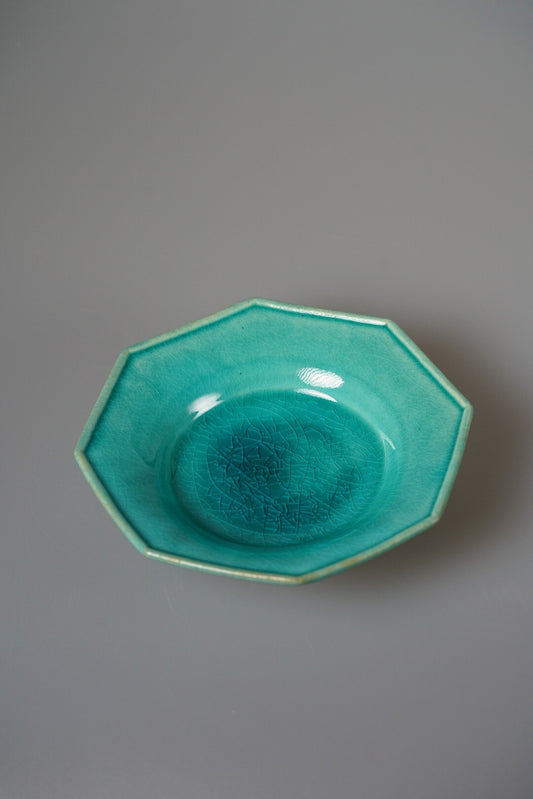 Octagonal plate in bright turquoise green glaze pooling darker in its round well.