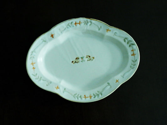 Pale green scalloped plate painted with a small pony and a ring of gold leaves around the rim.