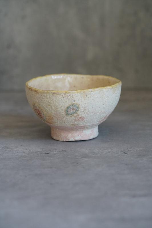 Footed bowl in speckled cream washed with pale blue, a soft blush of pink at the foot.