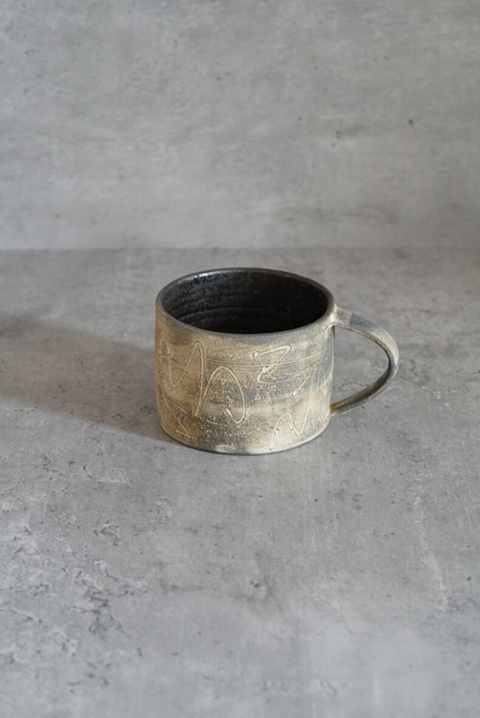 Low metallic-glazed mug in mottled silver grey with a slim wire-like handle.