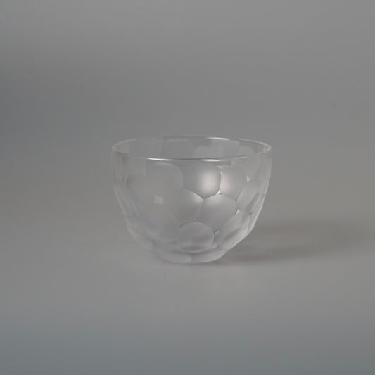 Clear glass bowl scattered with pale frosted circles across its thin walls.