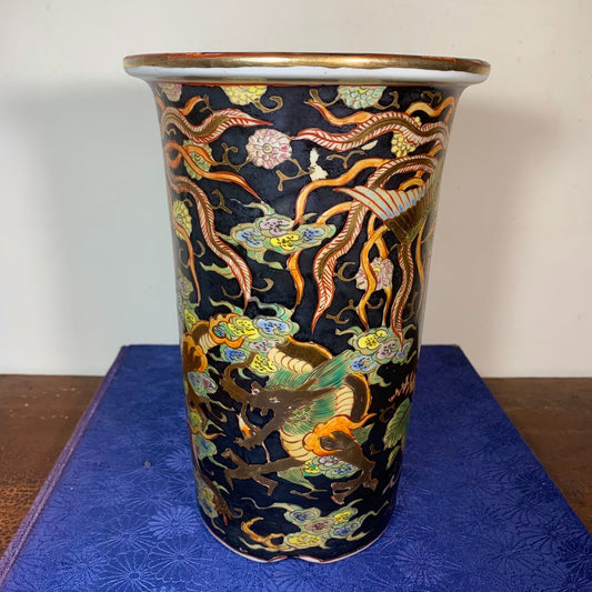 A tall, dark blue glazed pot with gold and multi-colored dragon motifs on its surface.