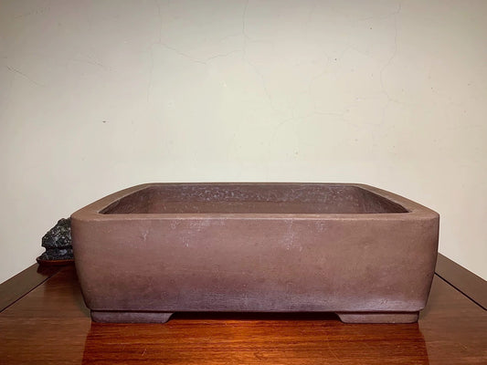 Rectangular brown unglazed ceramic pot with rounded corners and matte finish.