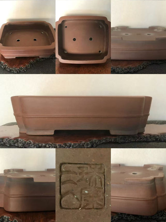 A rectangular brown unglazed clay pot with a stamped square mark and drainage holes.