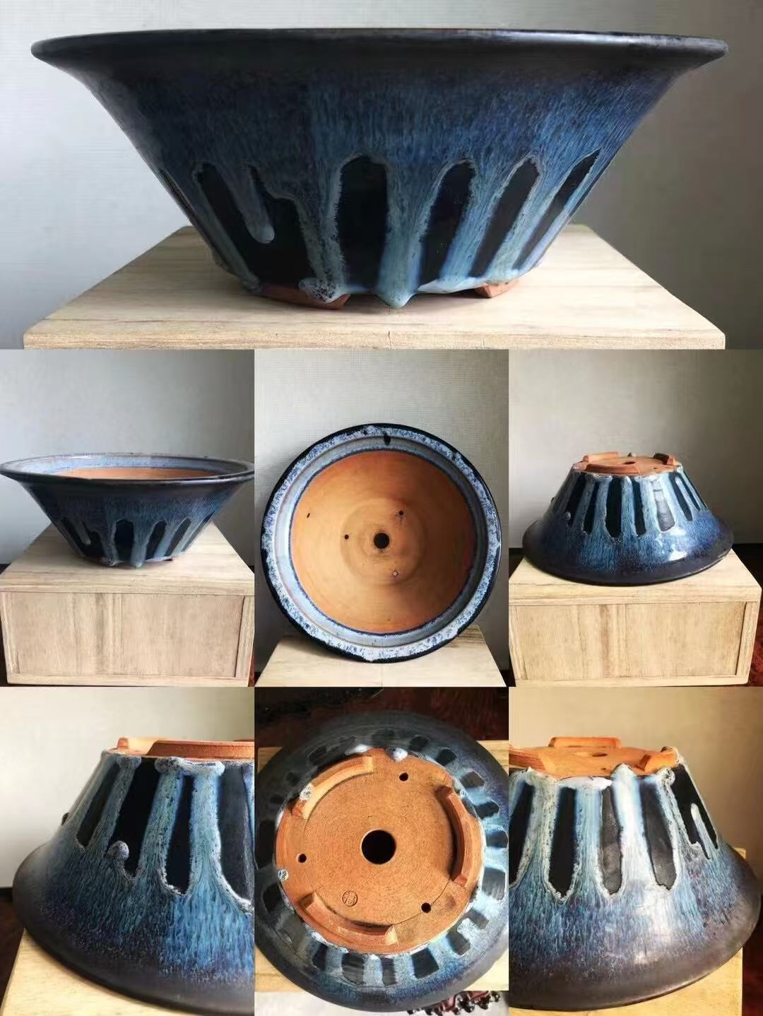 Dark blue glazed ceramic pot with flared rim and vertical slits, unglazed terracotta interior.