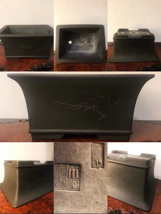 Dark grey glazed rectangular pot with carved characters and a square seal mark.