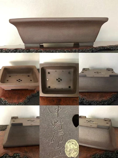 A matte brown rectangular pot with carved characters and a circular mark on its base.