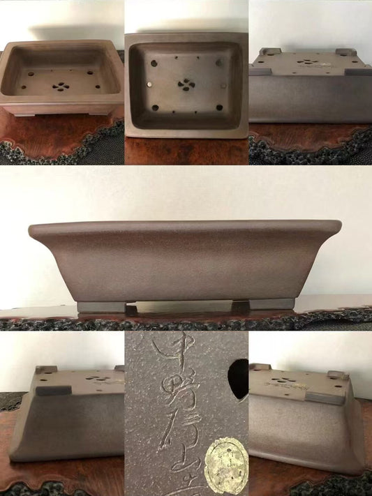 A matte brown rectangular pot with carved characters and a circular mark on its base.