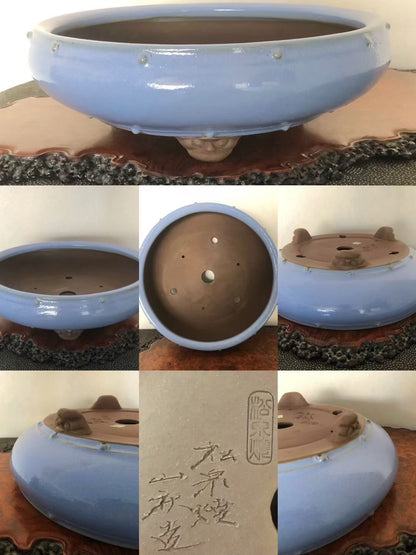 Light blue glazed pot with three feet, unglazed brown interior, and incised characters.