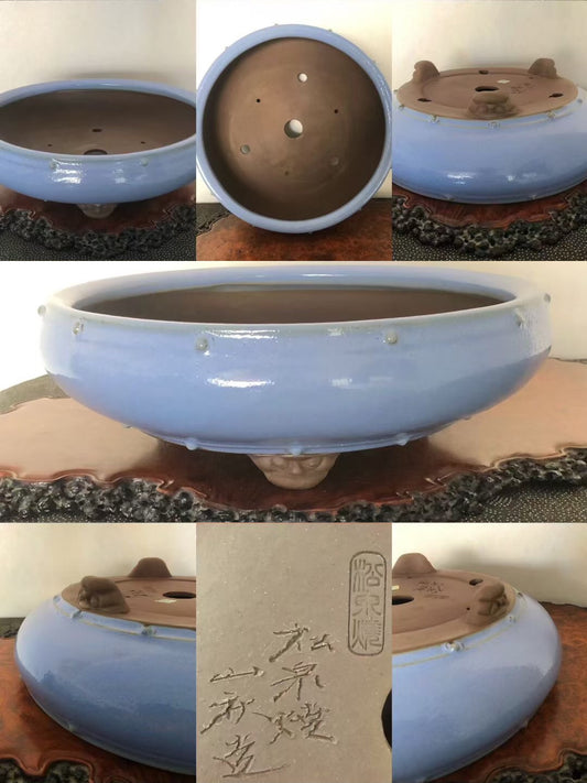 Light blue glazed pot with three feet, unglazed brown interior, and incised characters.