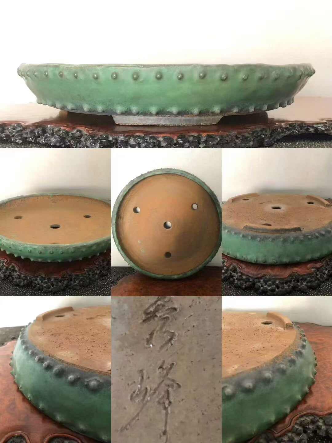 A green glazed pot with a scalloped rim and three drainage holes, showing a signature on its base.