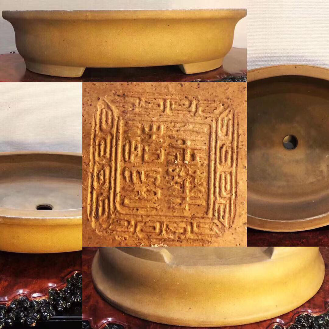 A yellow glazed ceramic bonsai pot with a square carved mark on its base.