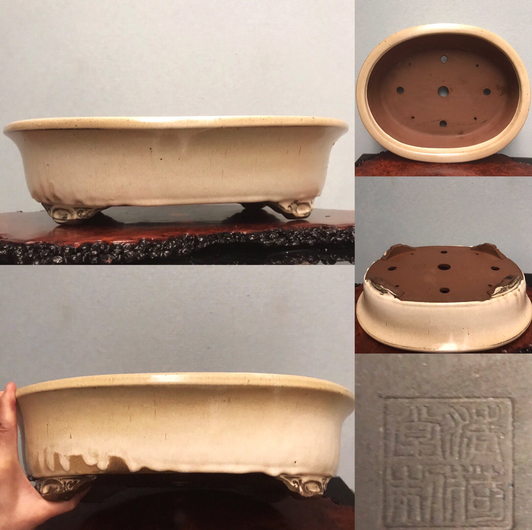 Cream glazed rectangular pot with four feet and a square seal mark.