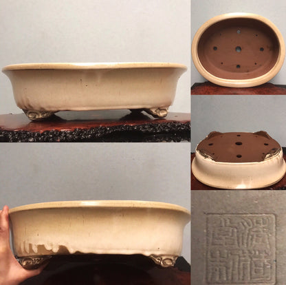 Cream glazed rectangular pot with four feet and a square seal mark.