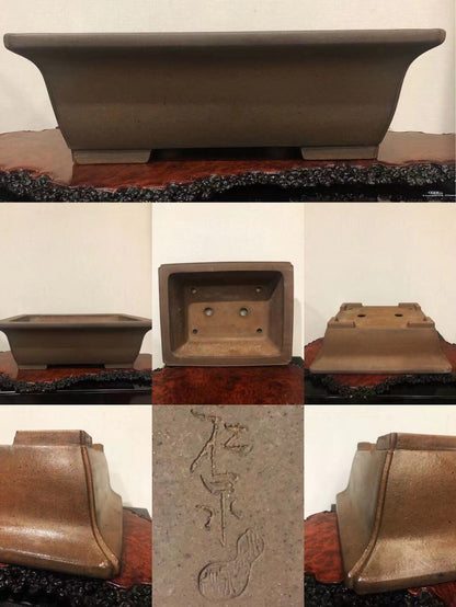 A matte brown ceramic bonsai pot with a rectangular base and incised character markings.