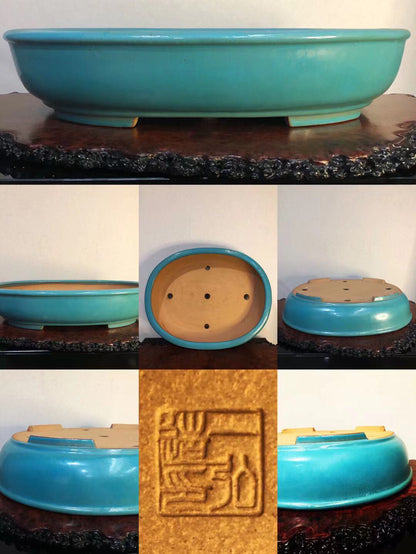 A glossy turquoise glazed pot with a square carved seal on its base.
