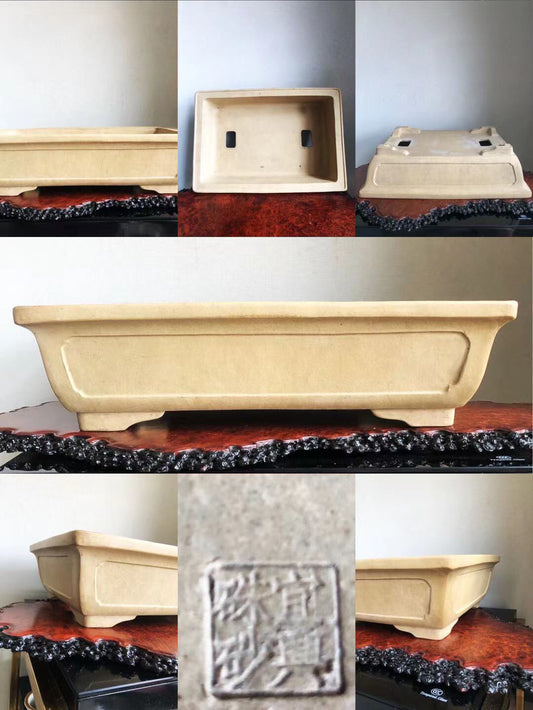 Beige rectangular ceramic pot with incised square mark and two small holes on base.