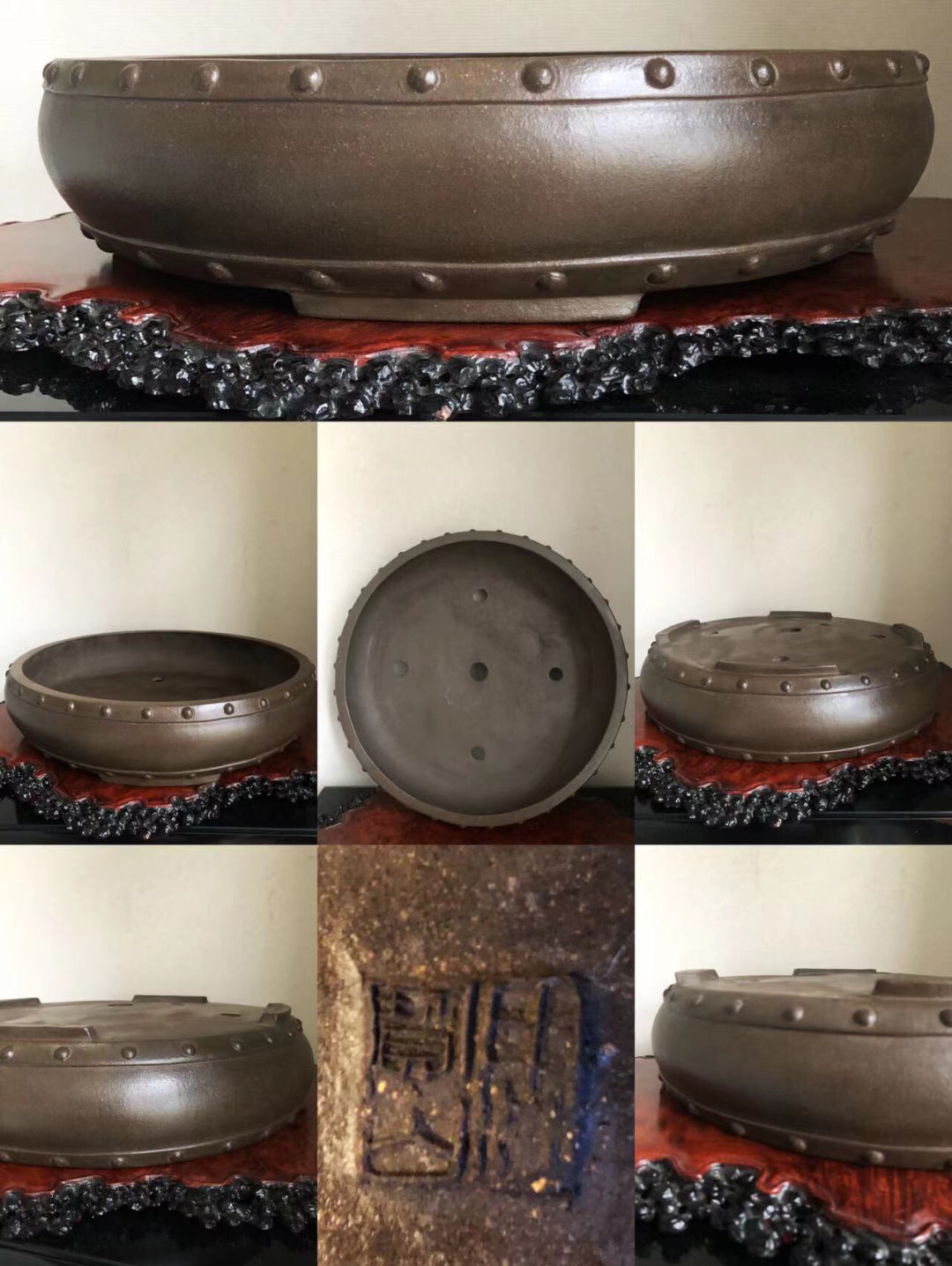 Dark brown glazed pot with rivet-like bumps around rim and a stamped mark on base.