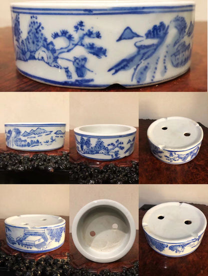 Five blue and white ceramic pots with landscape scenes, each with two drainage holes.