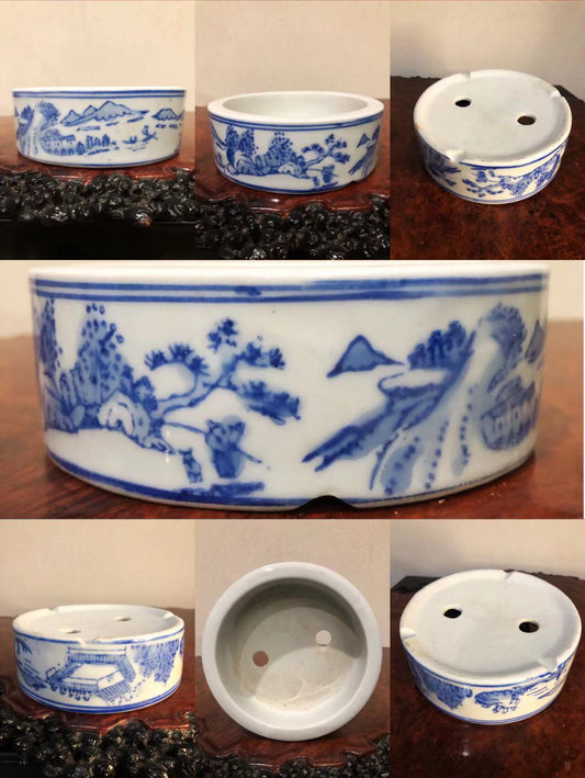 Five blue and white ceramic pots with landscape scenes, each with two drainage holes.