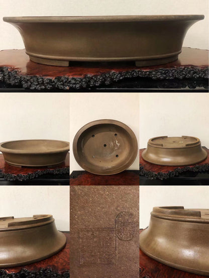 A matte brown ceramic bonsai pot with a wide rim and drainage holes, showing its base and interior.