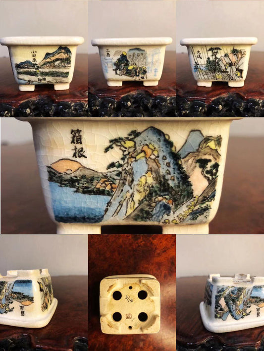 Five small white glazed pots, each with hand-painted landscape scenes and Japanese characters.