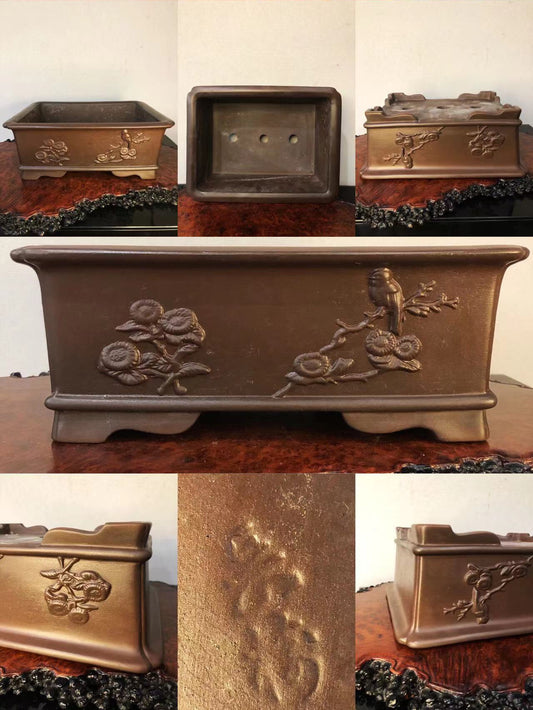 Dark brown rectangular pot with raised floral and bird relief, matte finish, showing interior and base.