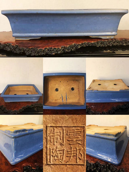 A rectangular blue glazed pot with a stamped square mark and two drainage holes.