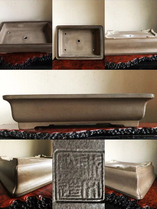 Rectangular grey glazed pot with raised rim and square maker's mark on base.
