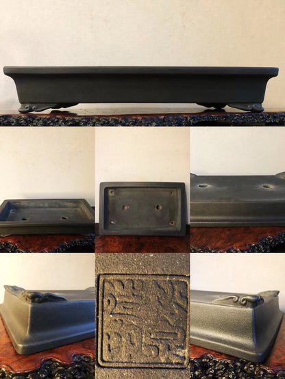 Dark grey rectangular pot with carved seal and two drainage holes, matte finish.