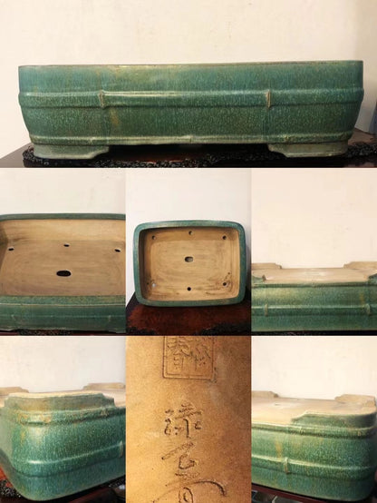 A green glazed rectangular pot with bamboo-style ridges and a stamped mark on its base.