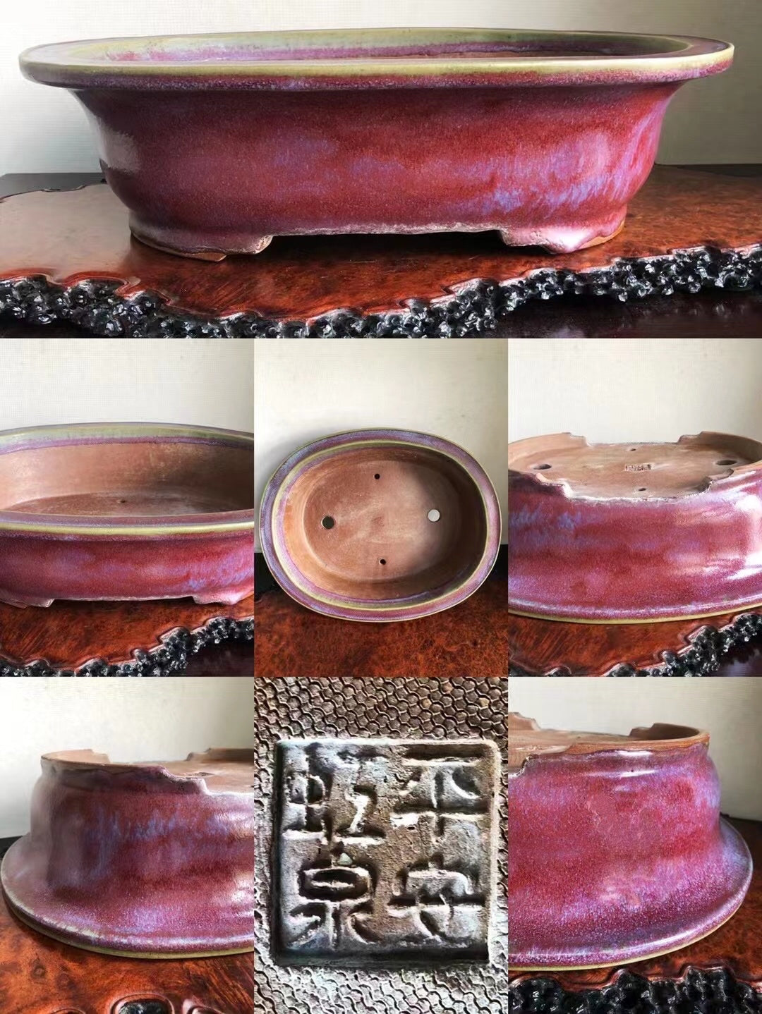A glossy, deep red glazed ceramic pot with a square seal mark and drainage holes.