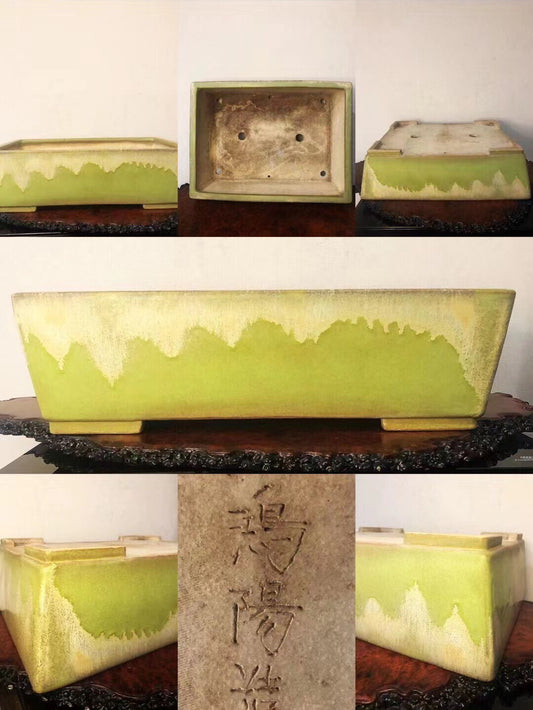 Rectangular glazed pot with lime green drip glaze and carved kanji on stone plaque.