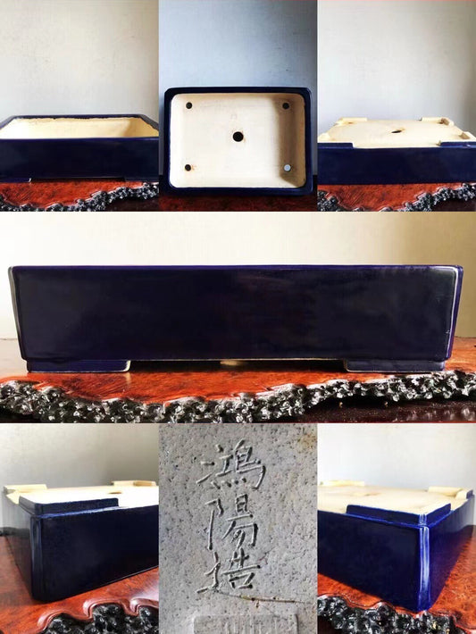 Rectangular dark blue glazed pot with cream interior, four screw holes, and vertical kanji characters on stone plaque.