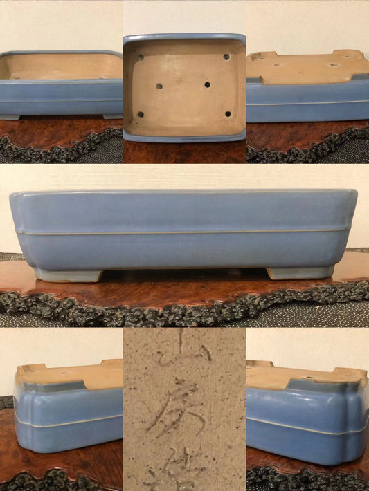 Rectangular blue glazed pot with gold rim, unglazed base, and visible maker's mark.