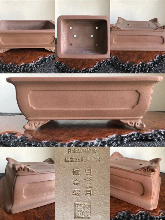 A matte brown rectangular pot with carved feet and a square base with four drainage holes.
