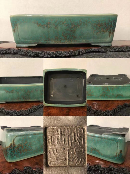 Rectangular turquoise glazed pot with brown speckles and a carved seal on its base.