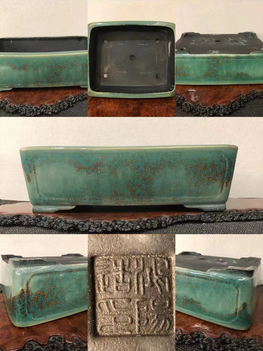 Rectangular turquoise glazed pot with brown speckles and a carved seal on its base.
