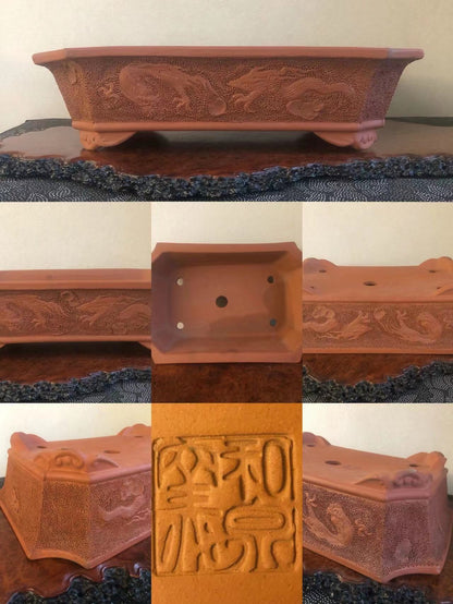 Rectangular terracotta pot with carved dragon motifs and a square base with a stamped seal.