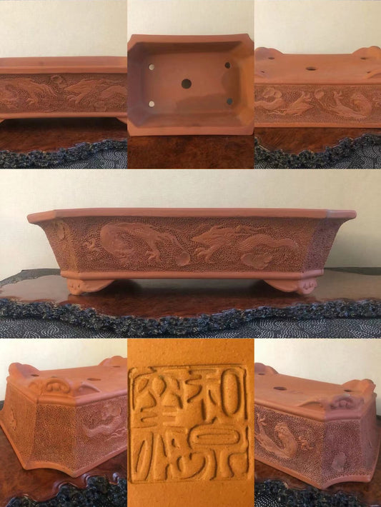 Rectangular terracotta pot with carved dragon motifs and a square base with a stamped seal.