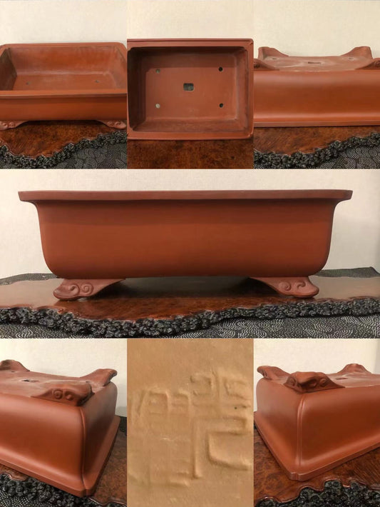 Rectangular terracotta pot with carved feet and impressed characters, matte finish.