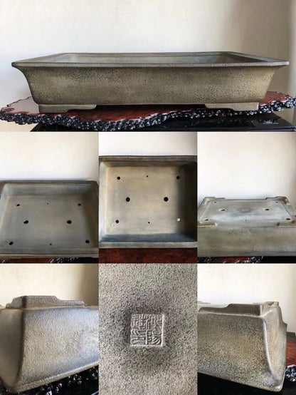 Rectangular grey glazed pot with speckled texture and stamped square mark on base.
