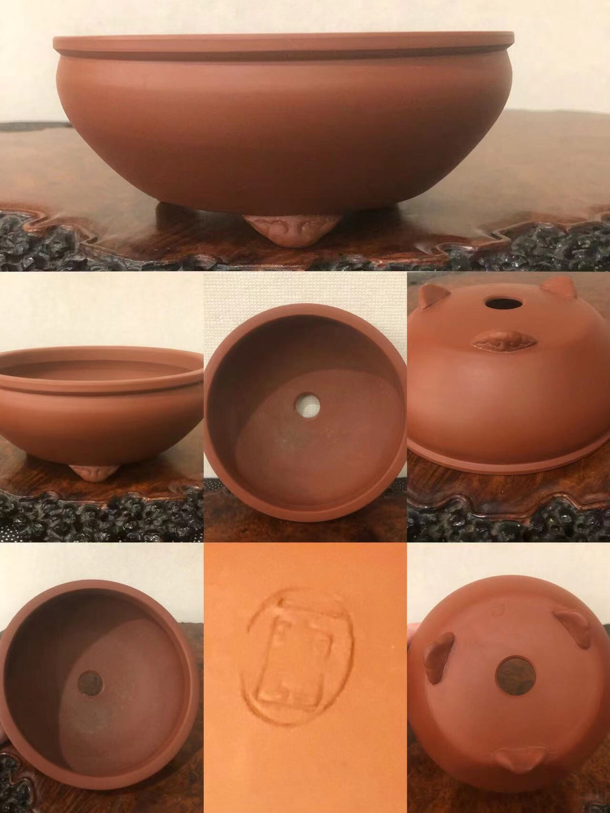 A terracotta bonsai pot with three feet, glazed reddish-brown surface, and a stamped square mark on the base.